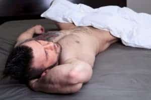 Hot gay man under a blanket