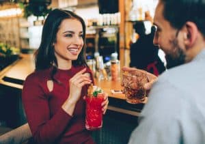 man talking to a woman at the bar