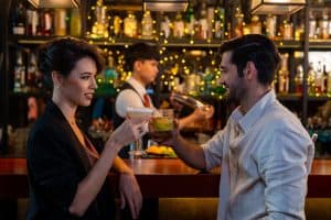 A man using a pickup line on a woman at a bar