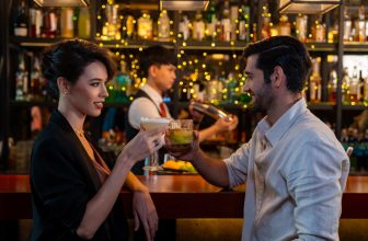 A man using a pickup line on a woman at a bar