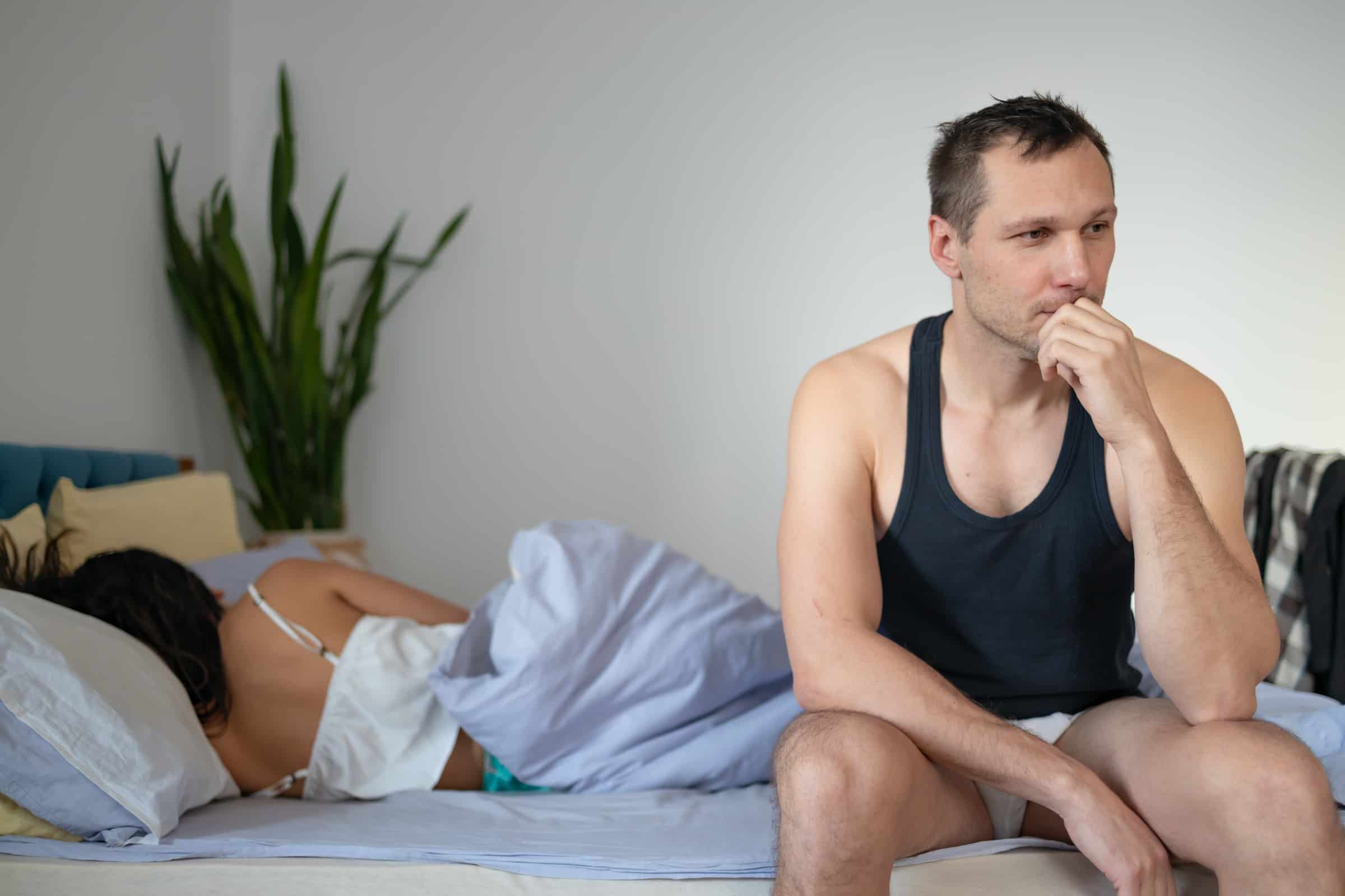 Stressed out man in bed with a woman
