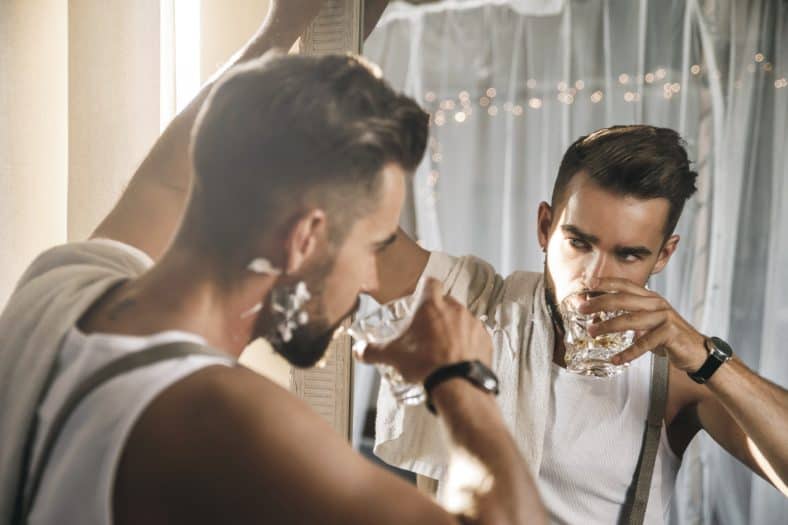 An autosexual man admiring himself in the mirror
