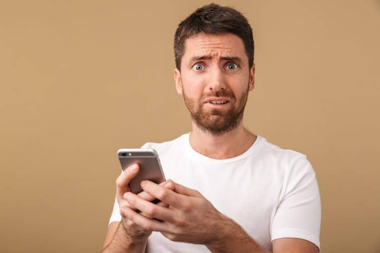 Confused man creating a dating profile on an online dating site