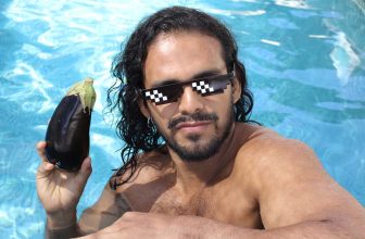 Funny photo of a man holding an eggplant.